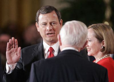 
Supreme Court Justice John Paul Stevens swears in John Roberts, with his wife, Jane, holding the Bible, as the 17th chief justice of the United States Thursday.
 (File/Associated Press / The Spokesman-Review)