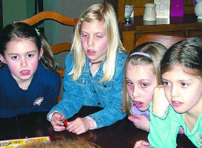 
From left, Emma Vandine, 8, Olivia Nilges, 8, Sophia Nilges, 10, and Mandy Nilges, 8 wait to find out if they have a correct answer during Family Game Night. 
 (The Spokesman-Review)