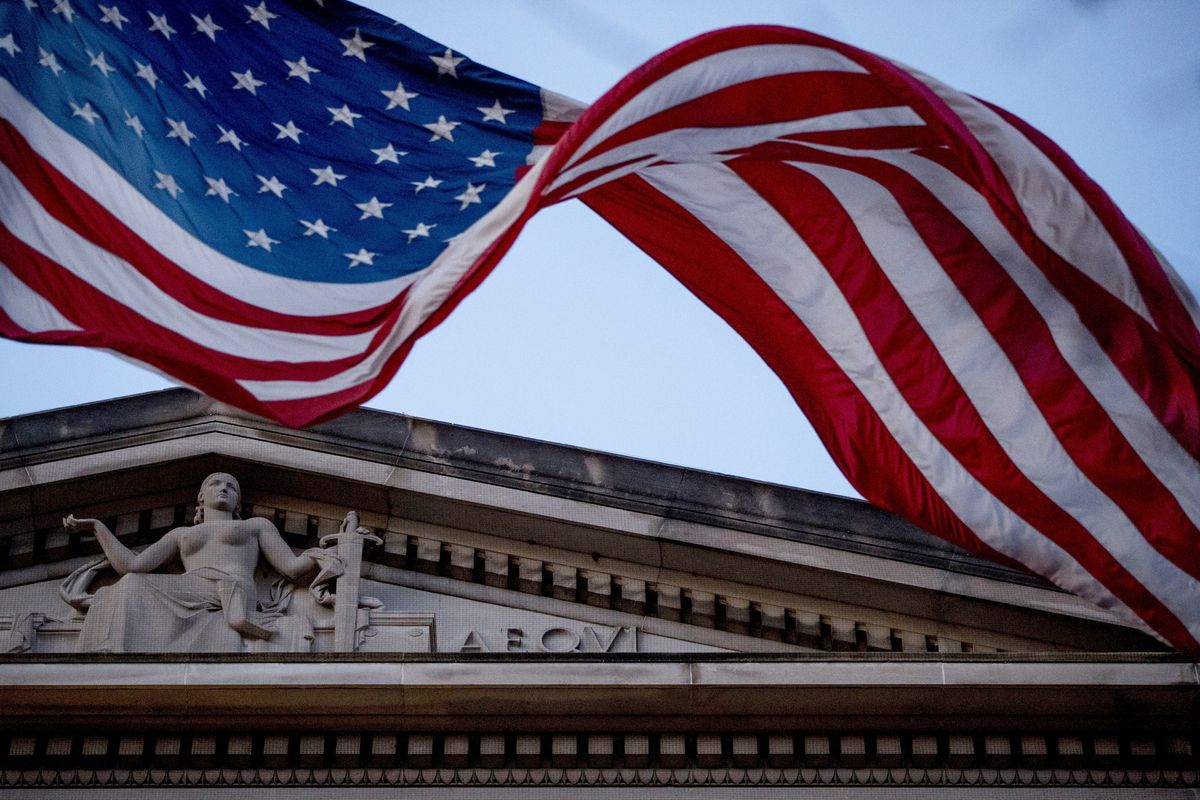FILE - In this March 22, 2019 file photo, an American flag flies outside the Department of Justice in Washington.   (Andrew Harnik)