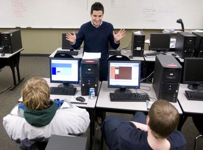 Tincan e-commerce curriculum teacher Brian Sniffen works with Rogers High School students Mathew West, left, and Donovan Sevier on a business plan.  (Colin Mulvany / The Spokesman-Review)