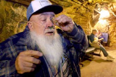 
Robert Flacher douses his eye with water seeping from the wall of the Merry Widow radon mine near Basin, Mont. Flacher visits the mine regularly for a variety of ailments, including cataracts. 
 (The Spokesman-Review)