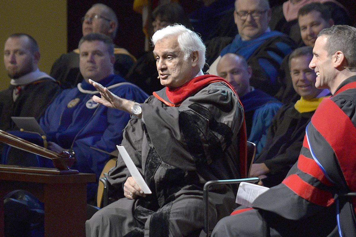 FILE - In this March 30, 2016 file photo, Ravi Zacharias, center, speaks during the Society of World Changers induction ceremony at Indiana Wesleyan University in Marion, Ind. A law firm