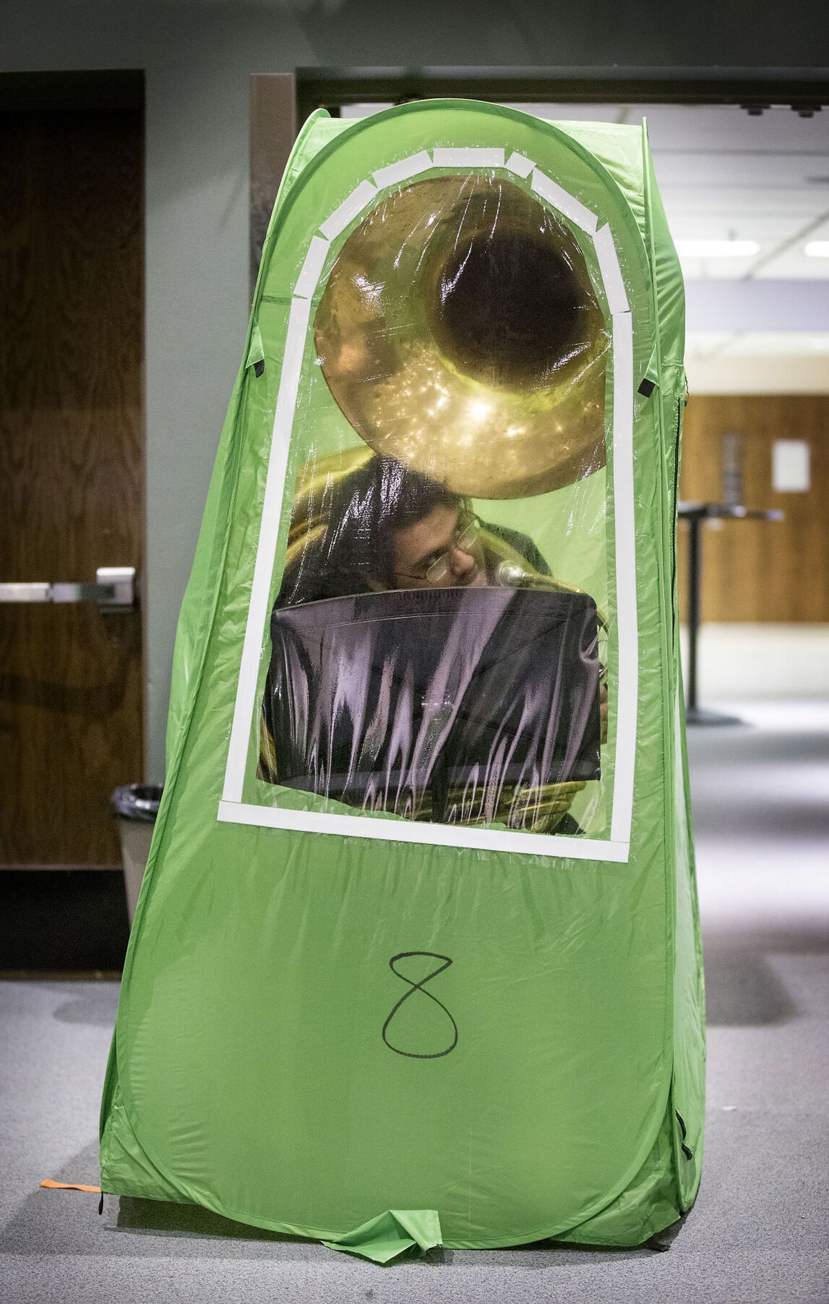 Juan Cruz fits into a small enclosure with hi sousaphone during band practice at Wenatchee High School on Tuesday.  (Don Seabrook/Wenatchee World)