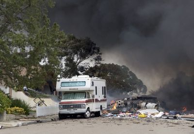 Part of the engine from an F-18 fighter jet is seen in a San Diego residential neighborhood after it crashed Monday. (Associated Press / The Spokesman-Review)