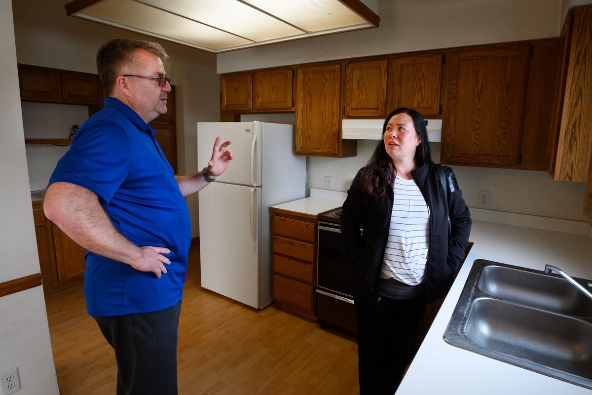 Ken Sax, designated broker at Keller Williams Realty, shows client Rosalind Weller a property in northwest Spokane, Thursday, April 11, 2019. (Colin Mulvany / The Spokesman-Review)