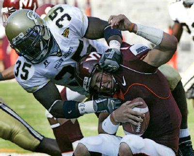 
Georgia Tech linebacker KaMichael Hall wraps up Virginia Tech quarterback Sean Glennon during the first half. 
 (Associated Press / The Spokesman-Review)