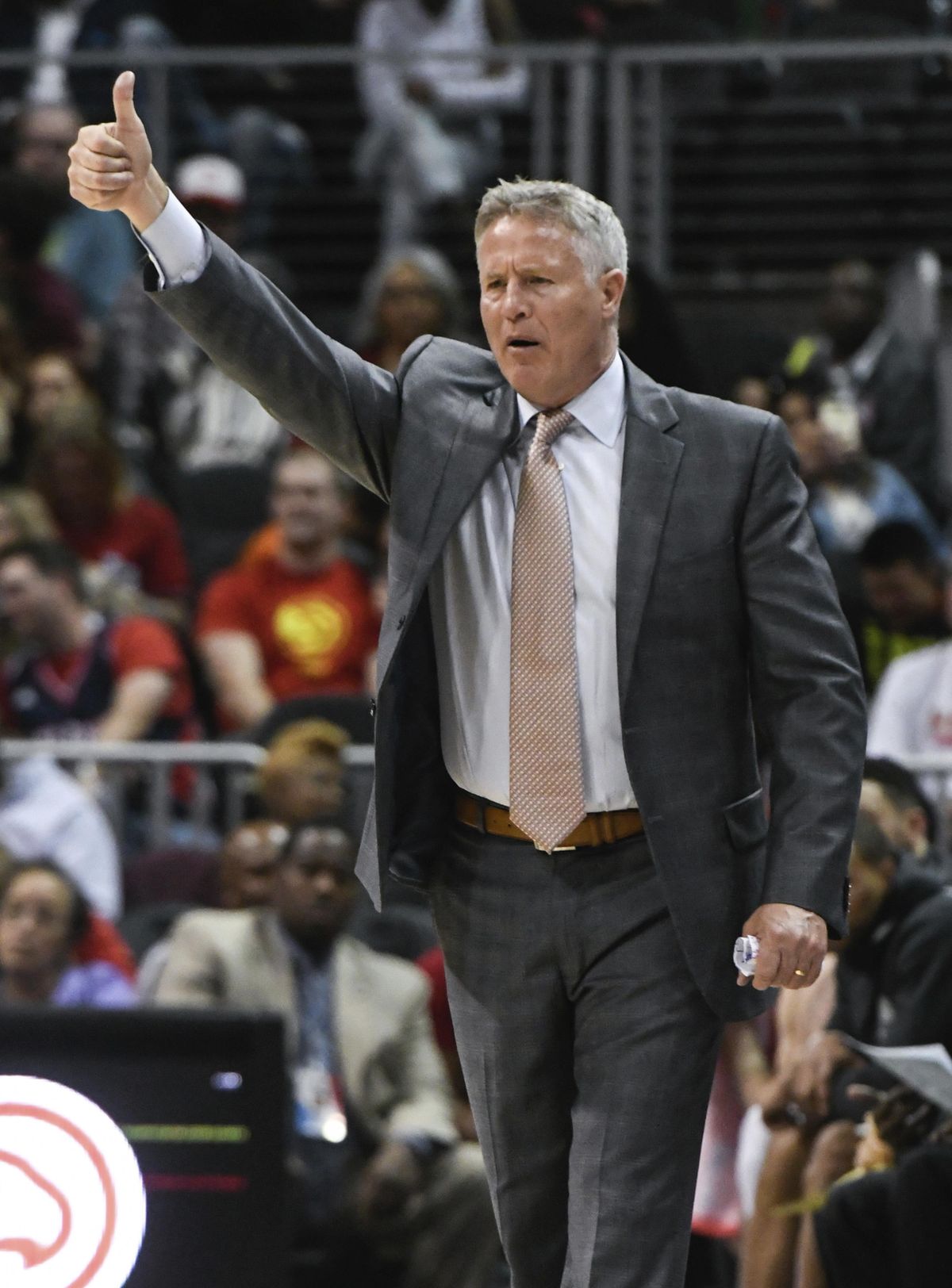 Philadelphia 76ers coach Brett Brown signals players during the second half of an NBA basketball game against the Atlanta Hawks Tuesday, April 10, 2018, in Atlanta. Philadelphia won 121-113. (John Amis / Associated Press)