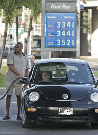 
Calvin Reddick pumps gas into his car last week in Honolulu. 
 (Associated Press / The Spokesman-Review)