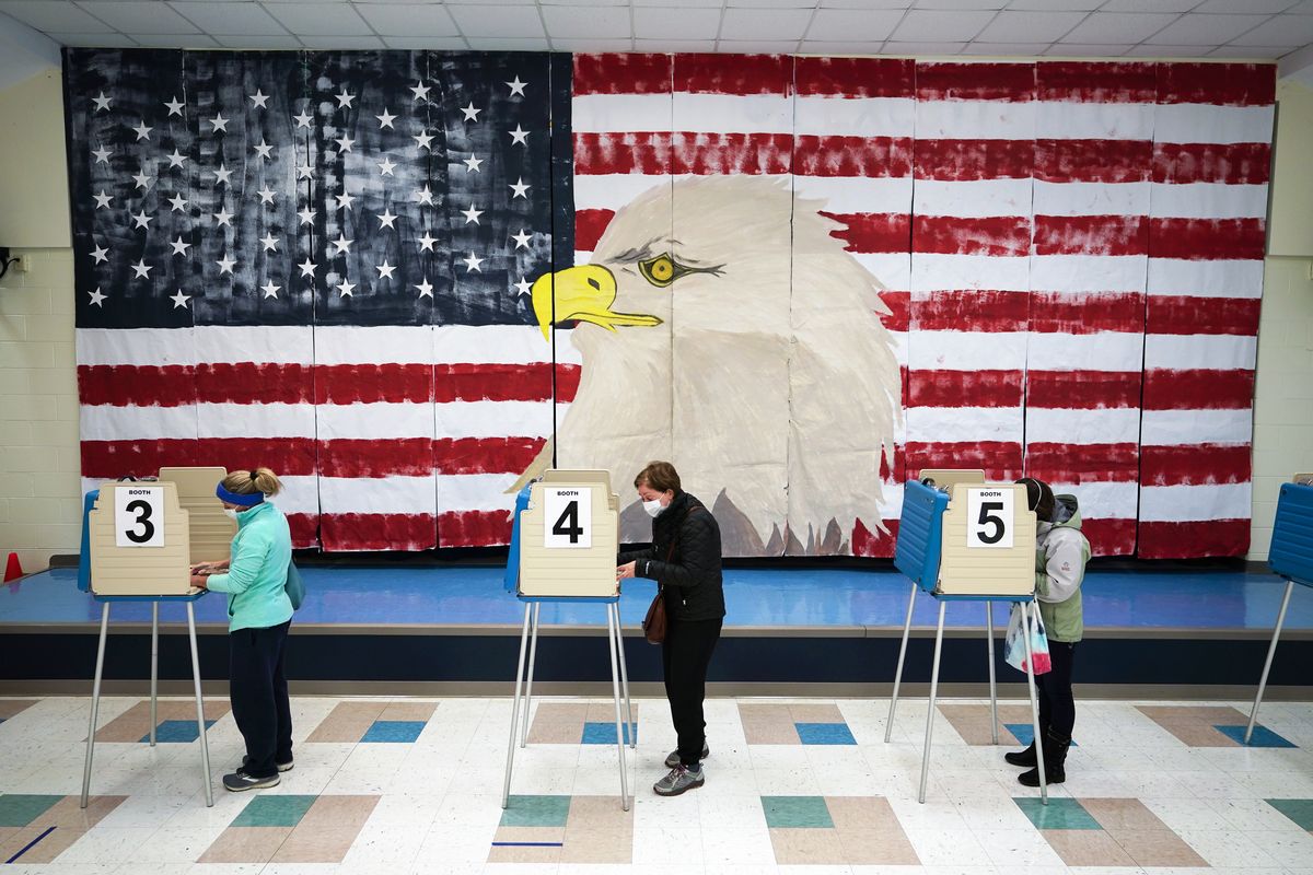 Voters cast their ballots under a giant mural at Robious Elementary school on Election Day, Nov. 3, 2020, in Midlothian, Va. In Virginia, Maryland, Nevada and other states where Democrats have control, lawmakers are pushing to make it easier to cast ballots by mail and increase early voting.  (Steve Helber)