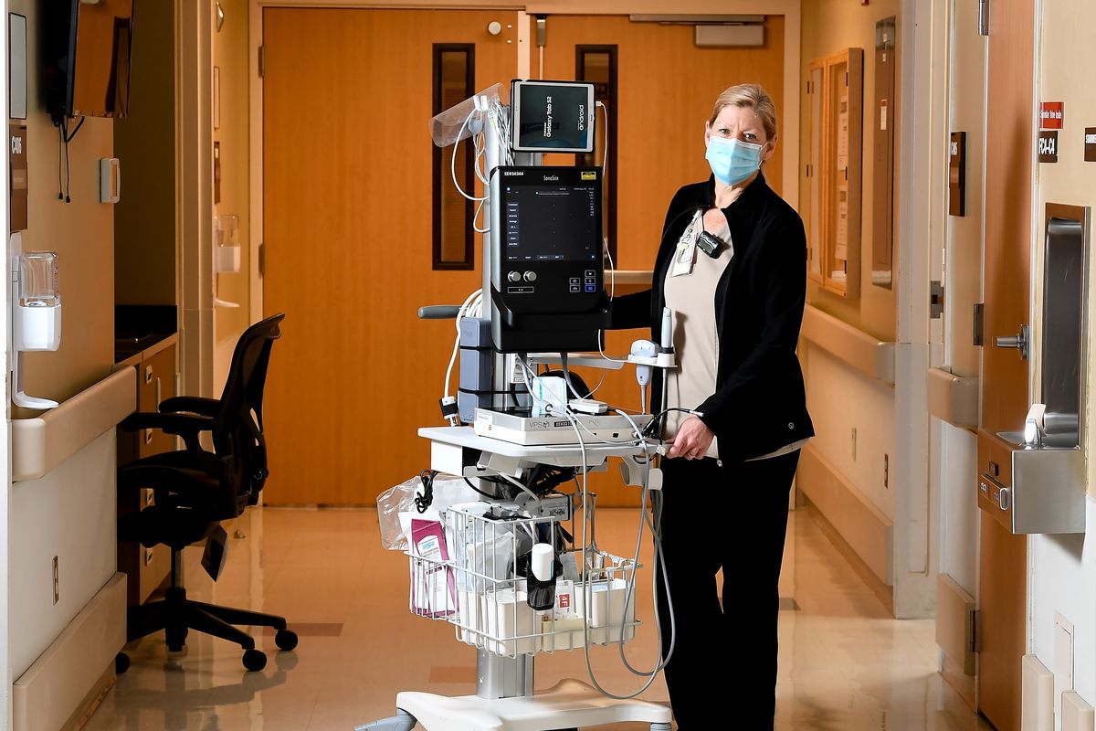 Terry Fisher, a vascular access coordinator with the Department of Veterans Affairs, poses for a photo Tuesday in one of the hallways she circulates daily with a cart carrying vascular access equipment she uses to diagnose patients at Mann-Grandstaff VAMC in Spokane.  (Tyler Tjomsland/THE SPOKESMAN-REVIEW)