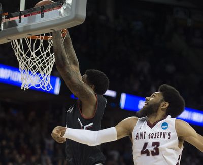 Cincinnati Bearcats forward Octavius Ellis dunks the ball to tie the game, but not before the clock ran out giving the 78-76 win to Saint Joseph's during the second half of a first round NCAA Division 1 Men's Basketball Championship game Friday in the Spokane Arena. (Colin Mulvany / The Spokesman-Review)