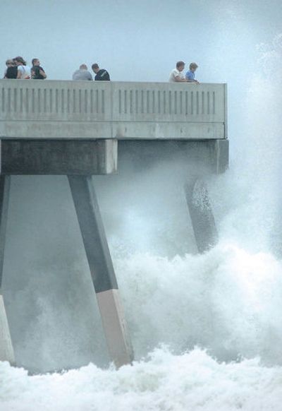 
Visitors at the end of the Johnnie Mercers Pier at Wrightsville Beach, N.C., are greeted by huge surf from Tropical Storm Ophelia. The storm was forecast to bring hurricane force winds to the area this morning. 
 (Associated Press / The Spokesman-Review)