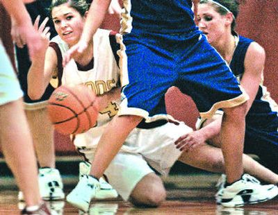 
U-Hi's Riki Schiermeister, left, battles Mead's Kami Clark for a loose ball on Tuesday night.
 (Brian Plonka / The Spokesman-Review)
