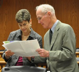 Redistricting Commissioner Slade Gorton, a former U.S. Senator, reviews a proposed map with Commission Chairwoman Lura Powell during a break in the Washington Redistricting Commission meeting on Tuesday, Sept. 13, in Olympia. (Jim Camden)