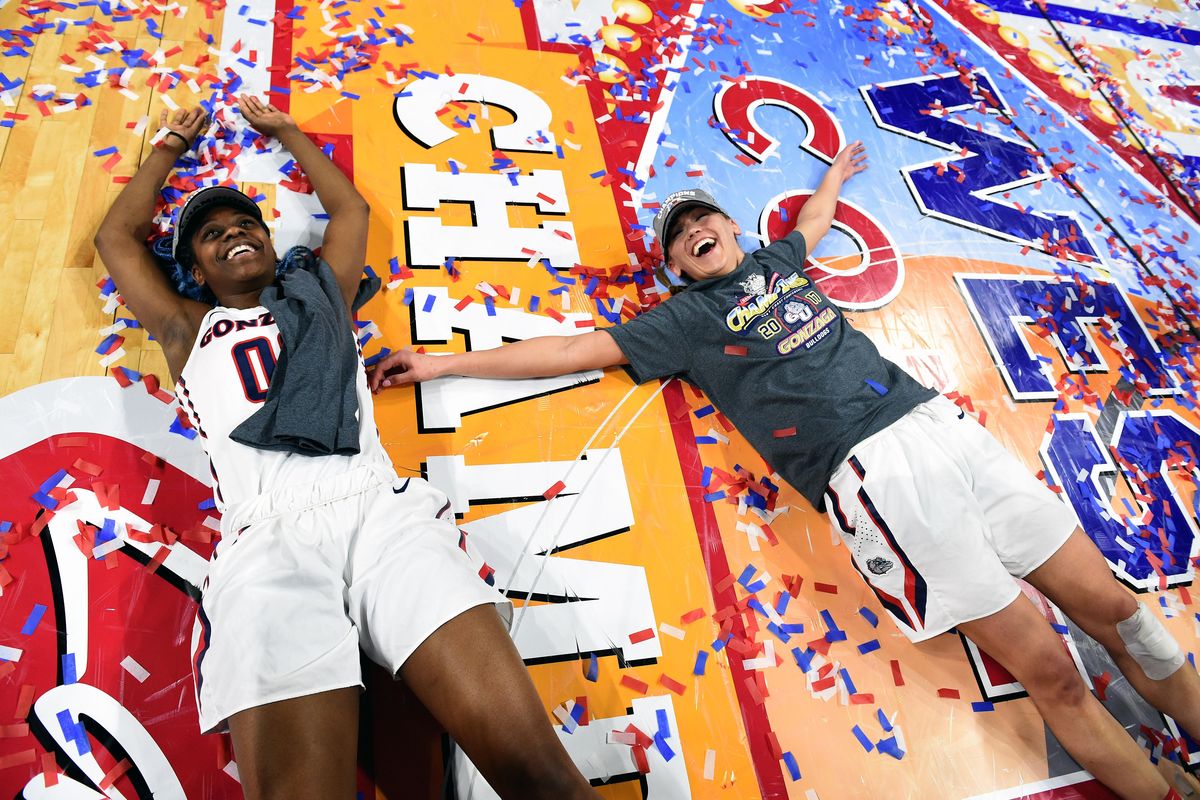 Gonzaga forward Zykera Rice (00) and Gonzaga guard Elle Tinkle (31) make confetti angels on the court after beating Saint Mary