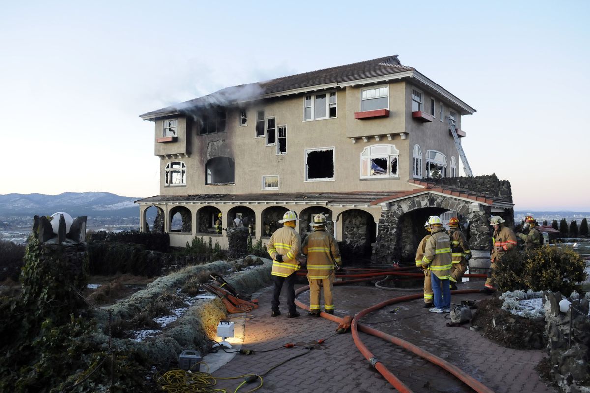 The Spokane Valley Fire Department responded to an early morning fire that burned portions of the landmark Cliff House mansion on the grounds of the Arbor Crest Wine Cellars overlooking the Spokane Valley. (J. Bart Rayniak / The Spokesman-Review)