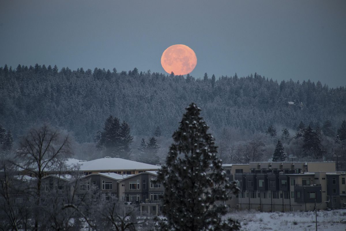 A full moon sets over the frozen landscape west of Spokane, Wash, Dec. 14, 2016. (Dan Pelle / The Spokesman-Review)