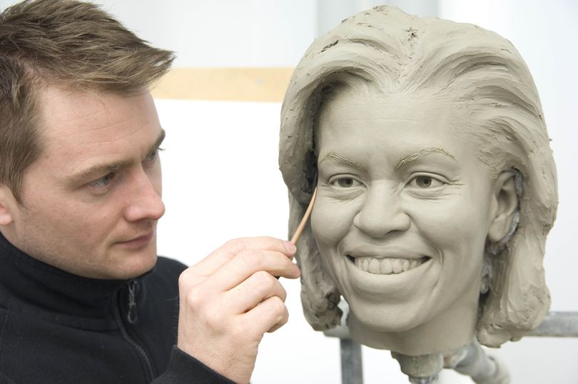 ORG XMIT: WX104 This image provided by Madame Tussauds shows senior sculptor Colin Jackson working on a clay head mold of first lady Michelle Obama at Merlin Studios in London. The clay molds are a crucial step in the up to six month-long figure creation process. The full wax figure of the new first lady is expected to be unveiled at Madame Tussauds in Washington in March. (AP Photo/Merlin Studios) (Merlin Studios / The Spokesman-Review)