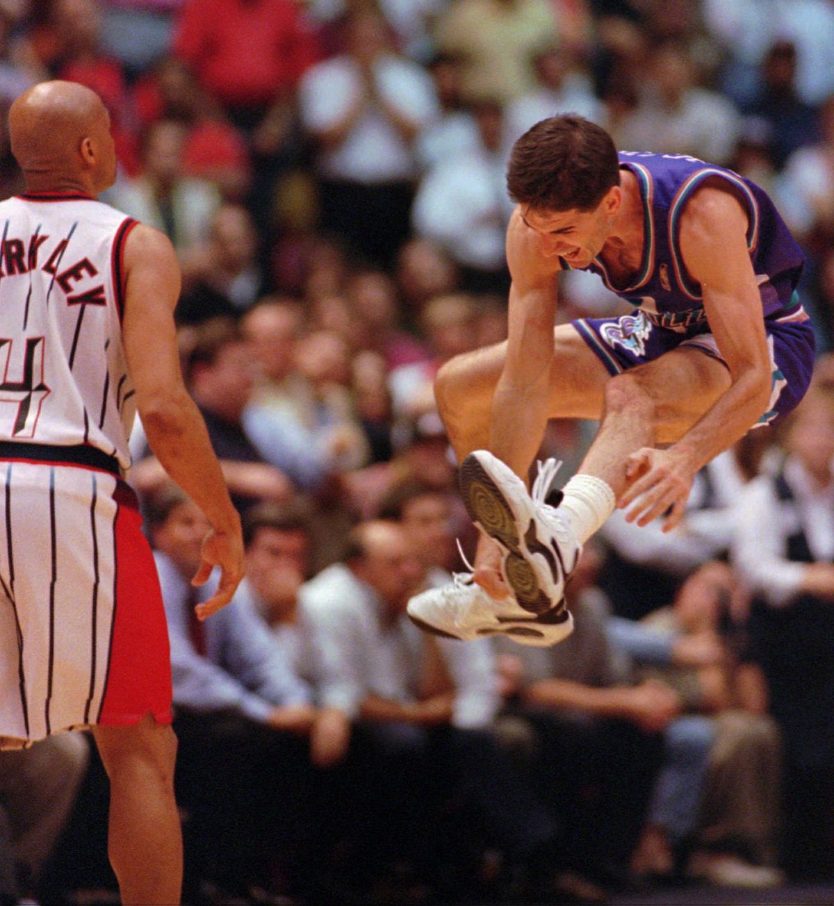 1997: Stockton launches the celebration after sinking a 3-point shot over Charles Barkley, left, at the buzzer to beat the Houston Rockets and send the Utah Jazz into the NBA Finals against the Chicago Bulls. (Associated Press / The Spokesman-Review)