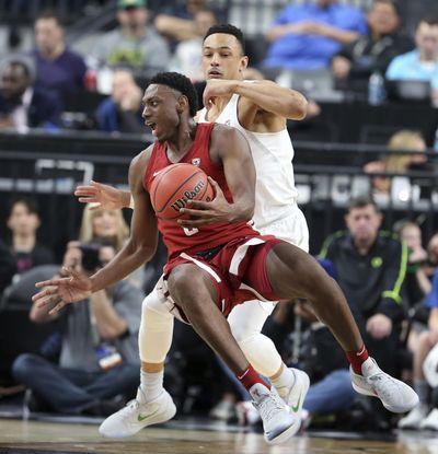 Washington State's Robert Franks, left, tries to pass as he falls to the court as Oregon's Elijah Brown defends during the first half of an NCAA college basketball game in the first round of the Pac-12 men's tournament Wednesday, March 7, 2018, in Las Vegas. (AP Photo/Isaac Brekken) ORG XMIT: NVIB157 (Isaac Brekken / AP)