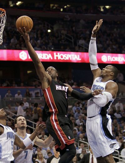 Dwight Howard, right, and Magic stopped Dwyane Wade’s Heat. (Associated Press)