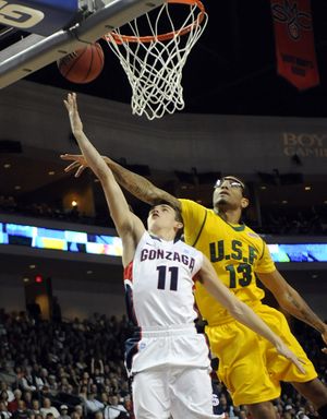 David Stockton of Gonzaga lays up the ball for a score over the defense of USF's Rashad Green (13) after he picked up a steal during first half action at the WCC Tournament in Las Vegas on Sunday, March  6, 2011. (Christopher Anderson / The Spokesman-Review)