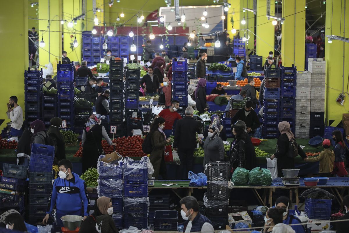 People shop at the local market in Istanbul, Thursday, April 29, 2021, a few hours before the start of the latest lockdown to help protect from the spread of the coronavirus. People stocked up on groceries, shoppers filled markets and many left cities for their hometowns or the southern coast as Turkey