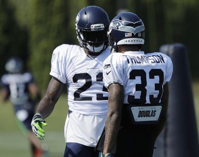 Seattle Seahawks free safety Tedric Thompson (33) talks with cornerback Neiko Thorpe, left, during NFL football training camp, Sunday, July 29, 2018, in Renton, Wash. (Ted S. Warren / AP)