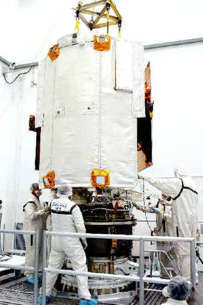 
Technicians at Astrotech Space Operations in Titusville, Fla., work on the Messenger, mating it with the Payload Assist Module, below, in this file photo.  
 (Associated Press / The Spokesman-Review)