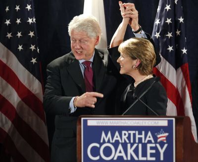 Former President Bill Clinton, left, clasps hands with Martha Coakley, right, candidate for the U.S. Senate seat left empty by the death of Sen. Edward M. Kennedy, D-Mass., at the conclusion of a campaign rally in Boston, Friday, Jan. 15, 2010. (Steven Senne / Associated Press)