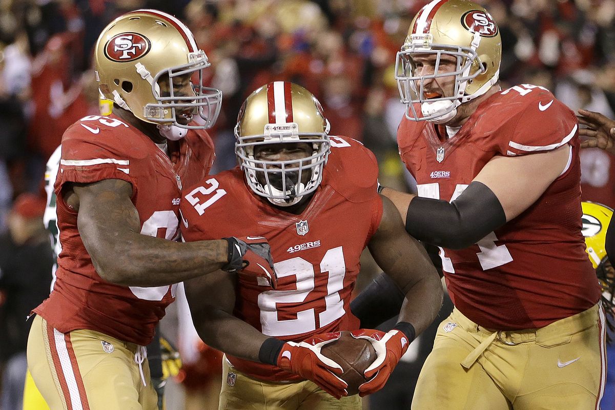 San Francisco’s Frank Gore (21) celebrates with Vernon Davis, left, and Joe Staley after scoring on a 2-yard run. (Associated Press)