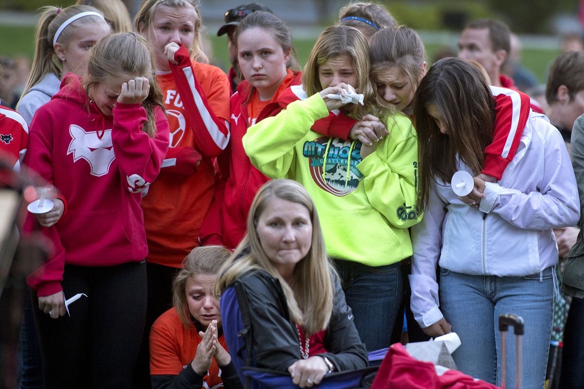 Friends gather for support as they listen to a song with the words “Dear Gracie, won’t you come out to play” at a memorial for Gracie Snider on Wednesday at Manito Park. Gracie was killed in an automobile accident east of Ritzville on Saturday. (Dan Pelle)