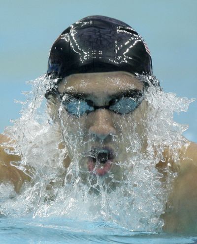 Michael Phelps set world record and won the gold in the 400 IM. (Associated Press / The Spokesman-Review)