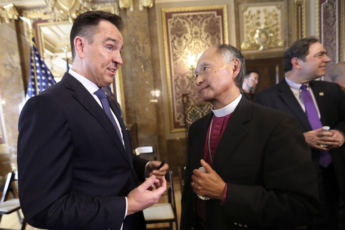 Utah House Speaker Greg Hughes and the Rt. Rev. Scott B. Hayashi, bishop of the Episcopal Diocese of Utah, talk after a press conference about a new medical cannabis policy in Utah during a press conference at the Capitol in Salt Lake City on Thursday, Oct. 4, 2018. (Kristin Murphy / Associated Press)