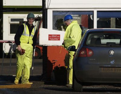 
Workers stand at the entrance of the Bernard Matthews turkey farm in Holton, England, on Saturday. Authorities confirmed  the H5N1 bird flu virus has been detected there. 
 (Associated Press / The Spokesman-Review)