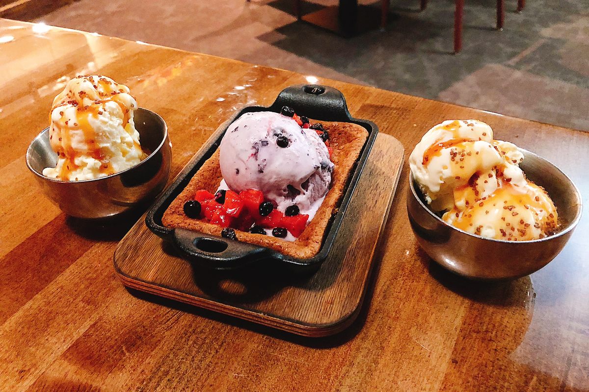 A hearth oven-baked blondie with huckleberry ice cream is flanked by nitrogen ice cream for two prepared tableside at Chinook Crafted by Adam Hegsted at Coeur d'Alene Casino in Worley.  (Don Chareunsy/The Spokesman-Review)