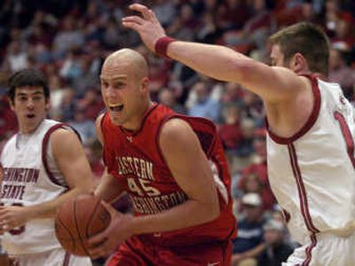 
EWU's Brandon Moore feels the pressure from Washington State's Aron Baynes, right, during the first half. Associated Press
 (Ingrid Barrentine Associated Press / The Spokesman-Review)