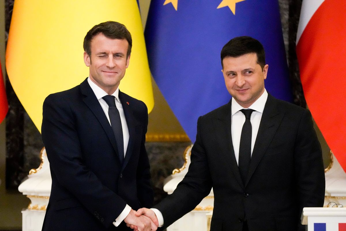 French President Emmanuel Macron, left, winks as he shakes hands with Ukrainian President Volodymyr Zelenskyy after a joint news conference following their talks in Kyiv, Ukraine, Tuesday, Feb. 8, 2022. Diplomatic efforts to defuse the tensions around Ukraine continued on Tuesday with French President Emmanuel Macron arriving in Kyiv the day after hours of talks with the Russian leader in Moscow yielded no apparent breakthroughs. (Efrem Lukatsky)