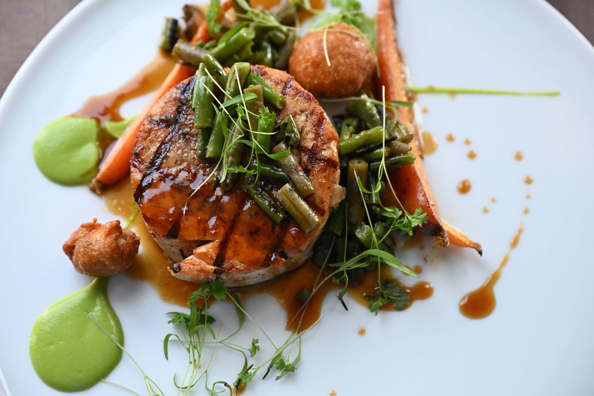 The Bowery restaurant's featured chicken dish, a ballotine made of both ground white meat and dark meat chicken, then finished on the grill and served with a mixed green bean salad and grilled carrots.  (Jesse Tinsley/The Spokesman-Review)