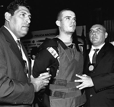 Police officers escort Joran van der Sloot during a press conference in Lima, Peru, on Saturday.  (Associated Press)