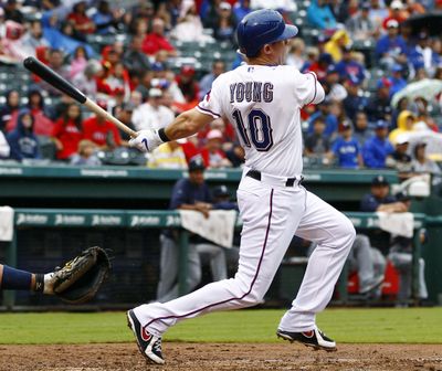 In this Sept. 16, 2012 photo, Texas Rangers’ Michael Young (10) singles against the Seattle Mariners in the fourth inning during a baseball game, in Arlington, Texas. The Texas Rangers will retire former infielder Michael Young’s No. 10 jersey number later this season, the team announced Tuesday, June 18, 2019. (Jim Cowsert / Associated Press)