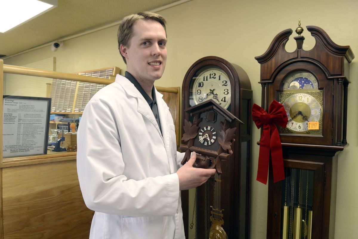 Ryan Fox, owner of Tick Tock Time Repair, holds a cuckoo clock that was brought in for repair, Friday, at his shop in Spokane Valley. Fox has three elite certifications in the world of watch repair. (Jesse Tinsley)