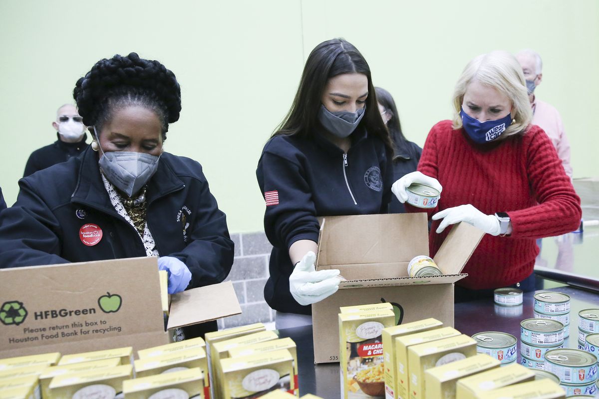 From left, U.S. Representatives Sheila Jackson Lee, Alexandria Ocasio-Cortez, and Sylvia Garcia, fill boxes at the Houston Food Bank on Saturday, Feb. 20, 2021. President Joe Biden declared a major disaster in Texas on Friday, directing federal agencies to help in the recovery.  (Elizabeth Conley)