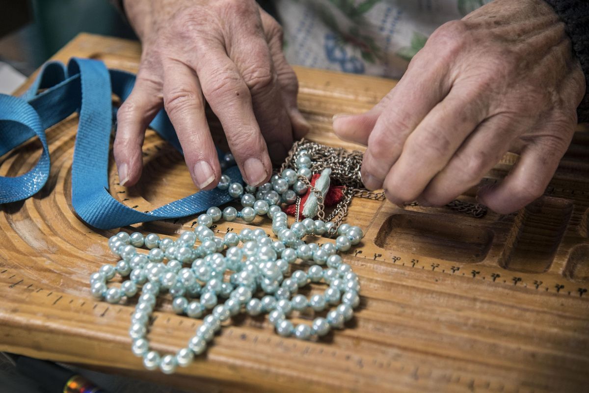 Joan Guerin, of South Hill Jewelers, does her best to untangle a necklace Tuesday, Oct. 4, 2016, brought in by Betty Duncan. (Dan Pelle / The Spokesman-Review)