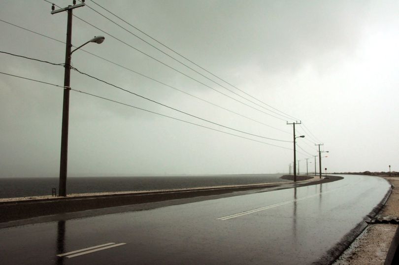 The seaside road leading to the international airport is empty as Hurricane Sandy approaches Kingston, Jamaica, Wednesday, Oct. 24, 2012. Hurricane Sandy pounded Jamaica with heavy rain as it headed for landfall near the country's most populous city on a track that would carry it across the Caribbean island to Cuba, and a possible threat to Florida. (Collin Reid / Associated Press)