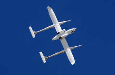 
A privately funded spacecraft is shown as it flies upside down above Mojave, Calif. Aircraft designer Burt Rutan hopes it will carry three people into suborbital space. 
 (AP / The Spokesman-Review)