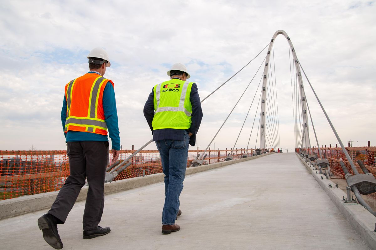 Washington State Governor Jay Inslee tours the University Gateway Bridge (right) alongside Spokane