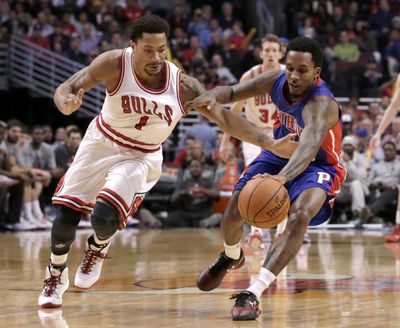 Bulls guard Derrick Rose battles Pistons guard Brandon Jennings for a loose ball during the second half of Chicago’s win. (Associated Press)