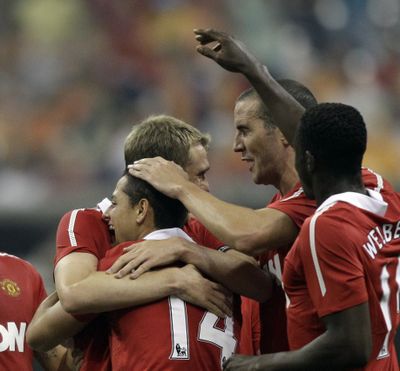 Manchester United's Javier Hernandez (14) is congratulated by teammates after scoring a goal in Wednesday’s game against the Major League Soccer All-Stars. (Associated Press)