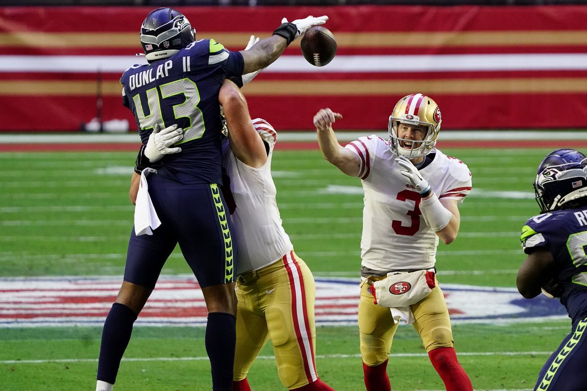 San Francisco 49ers quarterback C.J. Beathard (3) has his pass blocked by Seattle Seahawks defensive end Carlos Dunlap (43) during the first half of an NFL football game, Sunday, Jan. 3, 2021, in Glendale, Ariz.  (Rick Scuteri)